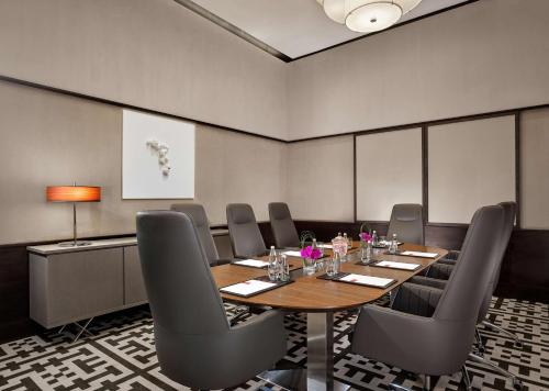 a conference room with a wooden table and chairs at Grand Hyatt Abu Dhabi Hotel & Residences Emirates Pearl in Abu Dhabi