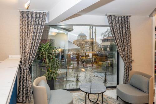 a room with a large window with chairs and a table at Baver Hotel in Istanbul