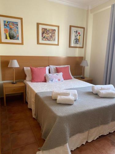 a bedroom with a large bed with two towels on it at Apartamento Altura T2 in Altura