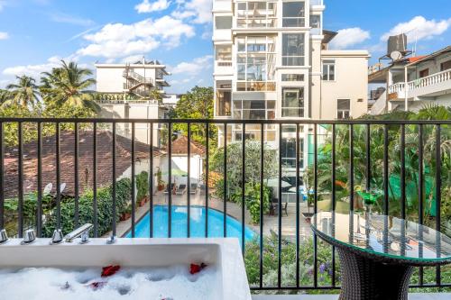 a balcony with a pool and a building at Quality Inn Ocean Palms Goa in Calangute