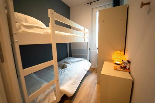 a bedroom with two bunk beds and a desk at Park Residence Il Gabbiano in Moniga