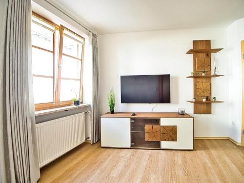 a living room with a flat screen tv on a wall at Ferienwohnung Bergliebe in Berchtesgaden