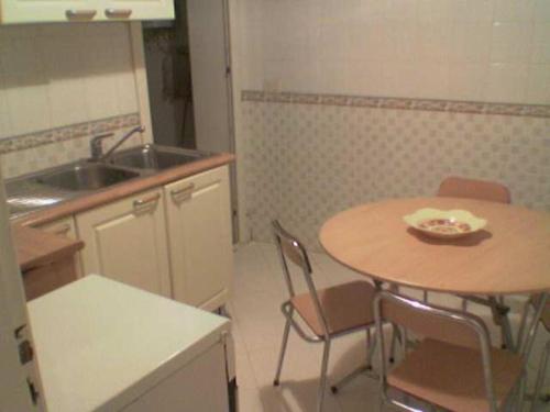 a kitchen with a table and chairs and a sink at My Second Home in Tunis