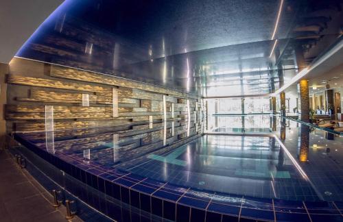 a large swimming pool in the middle of a building at Penthouse with Free PARKING and Free BIKES, wellness 8 min walk in Budapest