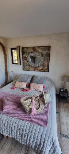 a bedroom with a bed with two bags on it at Le Clos Des Cambres in Les Arcs sur Argens
