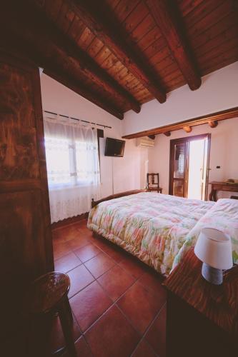 a bedroom with a bed and a television in it at B&B Casale degli Ulivi in Avola