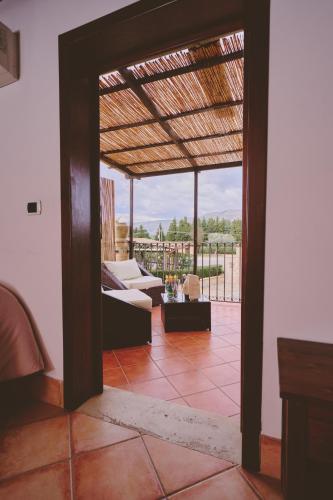 a living room with a view of a patio at B&B Casale degli Ulivi in Avola