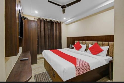 1 dormitorio con 1 cama grande con almohadas rojas en Hotel Silver Street, en Nueva Delhi