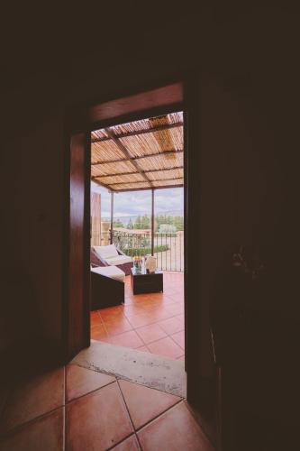a room with a view of a living room with a couch at B&B Casale degli Ulivi in Avola