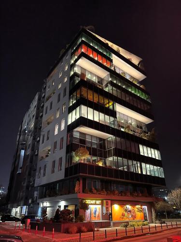 a tall building with many windows at night at Sunlight Luxe Apartment in Skopje