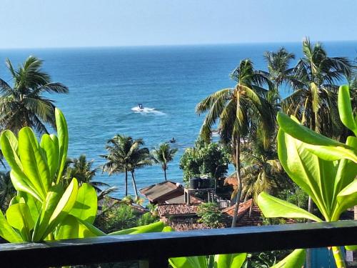 a view of the ocean from the balcony of a resort at X Mirissa in Mirissa