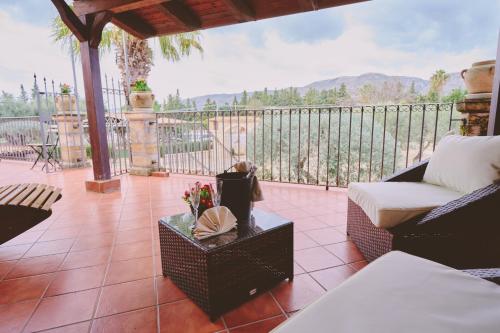 a patio with a couch and a table on a balcony at B&B Casale degli Ulivi in Avola