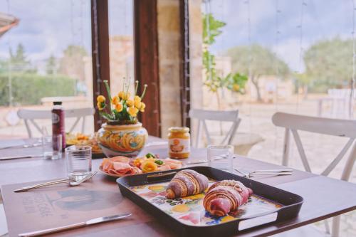 a table with a tray of food on a table at B&B Casale degli Ulivi in Avola