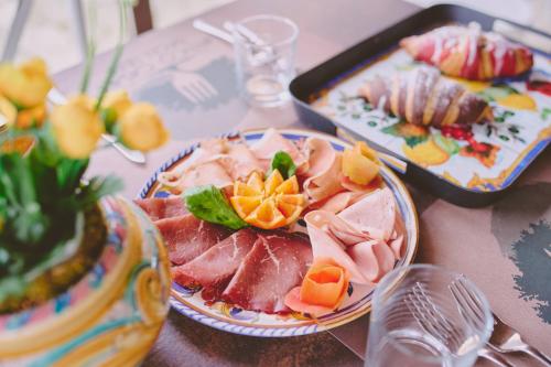 a table with two plates of food on a table at B&B Casale degli Ulivi in Avola
