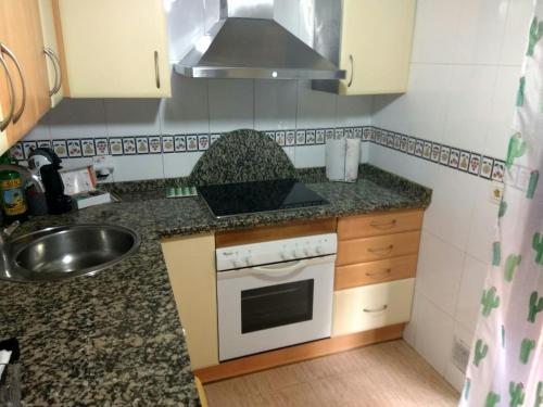 a kitchen with a sink and a stove top oven at VUT Casa Miranda 51 in Salamanca