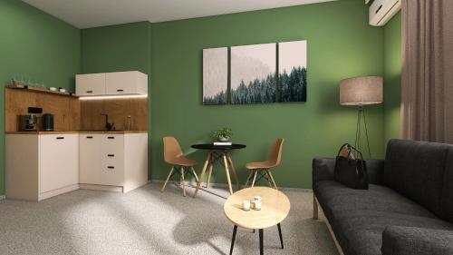 a living room with a couch and a table and a kitchen at Hotel Etropol, Center Etropole in Etropole