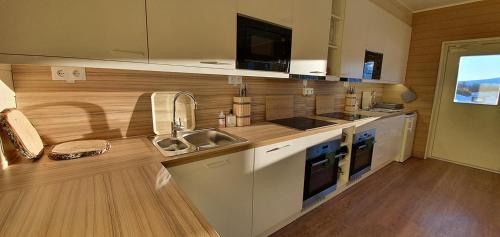 a kitchen with a sink and a counter top at Umfors Camping in Umasjö