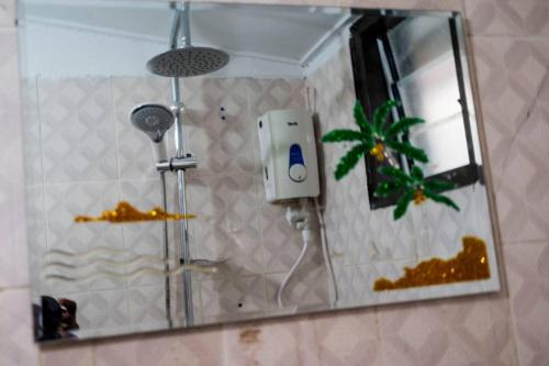 a mirror in a bathroom with a shower at Stunning 4-Bed Villa in cocody engre Abidjan in Cocody