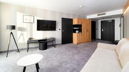 TV o dispositivi per l'intrattenimento presso Aparthotel Czarna Perła - Czarna Góra Resort, Sun & Snow
