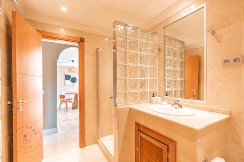 a bathroom with a sink and a mirror at Stylish Apartment Aloha Hill Club Marbella - TCM in Marbella