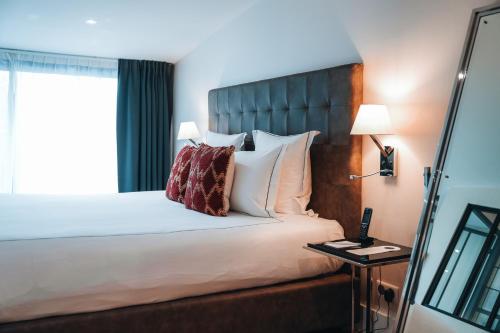 Un ou plusieurs lits dans un hébergement de l'établissement Le Palais Gallien Hôtel & Spa