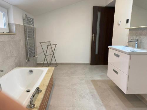 a bathroom with a bath tub and a sink at Casa Sofia in Satu Mare
