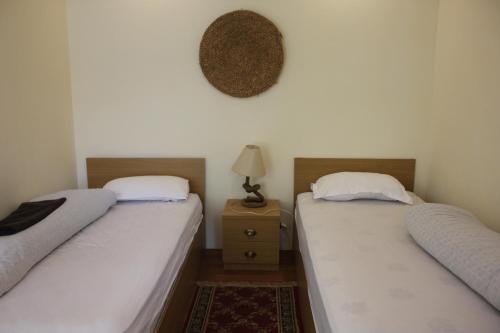 two beds sitting next to each other in a room at KAJI HOME in Pātan