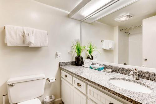a bathroom with a sink and a toilet and a mirror at Evergreen Condominiums by Keystone Resort in Keystone