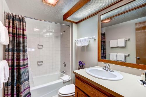 a bathroom with a sink and a tub and a toilet at Evergreen Condominiums by Keystone Resort in Keystone
