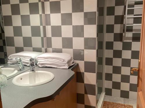 a bathroom with a sink and a checkerboard wall at Guestroom Basse-sur-le-Rupt, 1 pièce, 2 personnes - FR-1-589-624 in Basse-sur-le-Rupt