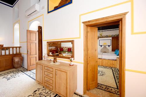 a room with a wooden door and a bedroom at Villa Annoula - Traditional Lindian House in Lindos