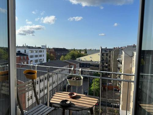a balcony with a table and a view of a city at Penthouse: Copenhagen delight in Copenhagen