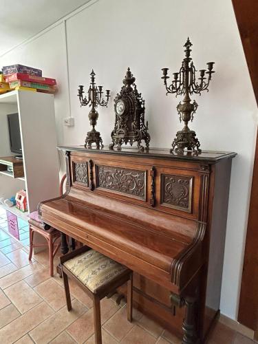 a wooden piano with two lights on top of it at Villa per gruppi fino a 20 persone, con piscina privata, camino e grande giardino nelle colline marchigiane in Pian di Mulino