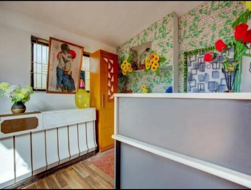 a living room with flowers on the walls at HILL BIRD HOME STAY Ooty in Ooty