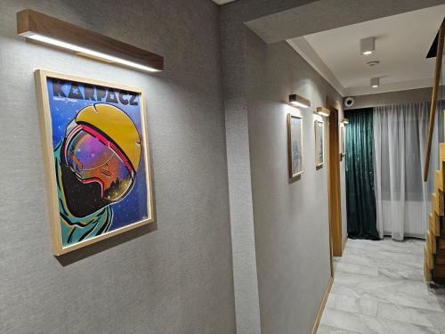 a hallway with a painting of a football on the wall at Richmount Apartamenty Karpacz in Karpacz