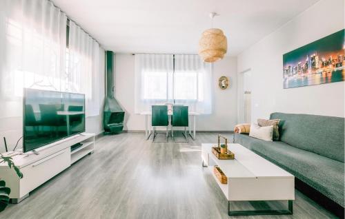 a living room with a couch and a tv at Nice Home In Valldemar With Wifi in Gornal