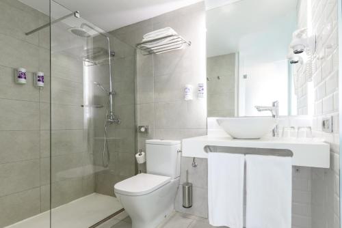 a bathroom with a toilet and a sink and a shower at FERGUS Cactus Garden in Playa Jandia