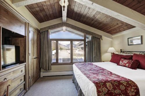 a bedroom with a large bed and a window at Lodge at Vail, A RockResort in Vail