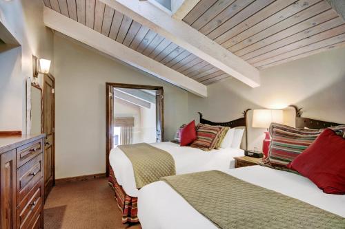 a bedroom with two beds and a window at Lodge at Vail, A RockResort in Vail