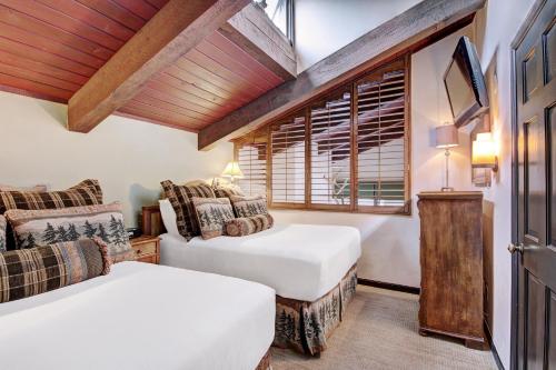 a bedroom with two beds and a window at Lodge at Vail, A RockResort in Vail