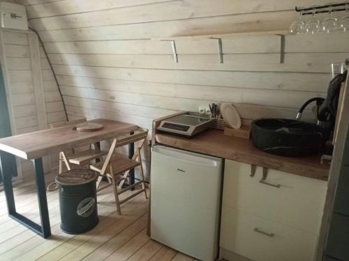 a kitchen with a counter and a table and a table at Domaine de Cozance chambres d'hôtes et gîte in Anjou