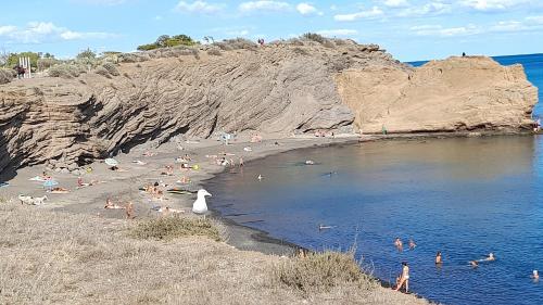 a group of people on a beach near the water at Cap Saint Martin Marina in Cap d'Agde