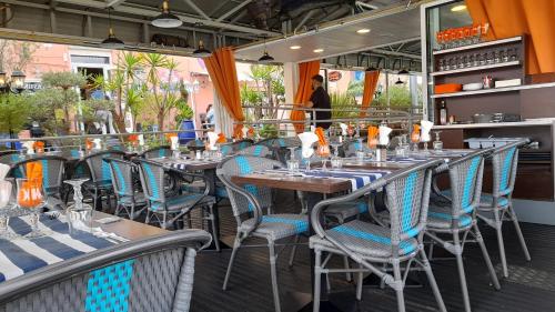 a row of tables and chairs at a restaurant at Cap Saint Martin Marina in Cap d'Agde