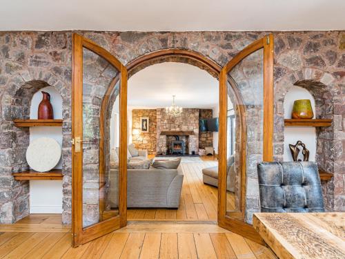 a living room with a stone wall at Brookway Lodge in Holywell