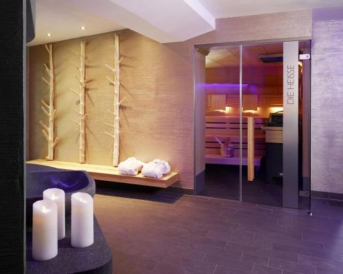 a bathroom with white candles in a room at Verwöhn-Wellnesshotel Walserhof in Hirschegg