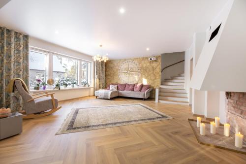 a living room with a couch and a fireplace at Cozy private house in Nõmme in Tallinn