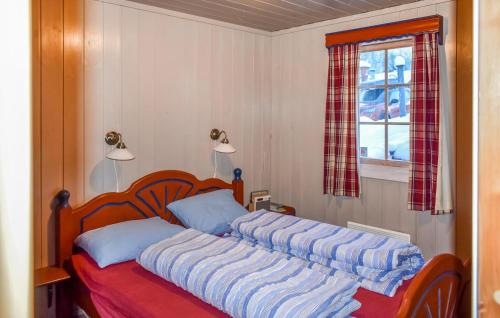 a bedroom with a bed with two pillows and a window at Lovely Home In Geilo With Wifi in Geilo