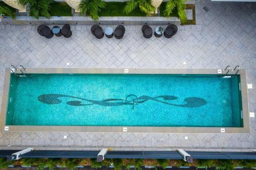 an overhead view of a swimming pool with a pair of sunglasses at Golden Tulip Lekki in Lekki