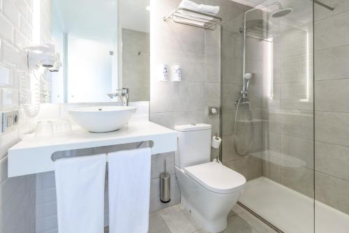 a bathroom with a toilet and a sink and a shower at FERGUS Cactus Garden in Playa Jandia