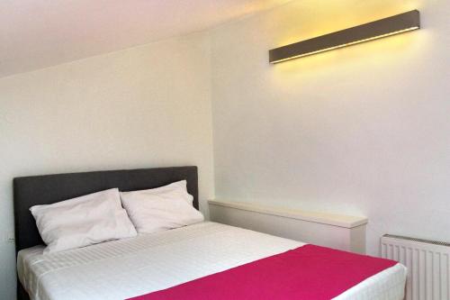 a bedroom with a bed with a red and white blanket at VIVIAN Art Apartments in Rethymno Town